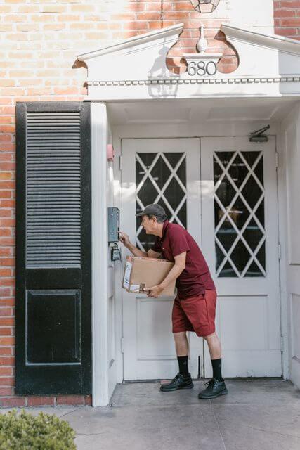 A delivery person rings the doorbell.